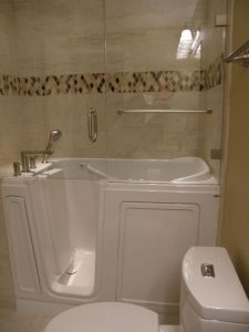 Walk in Bath with glass enclosure and tile surround