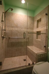 Tile surround shower with bench seat and glass enclosure